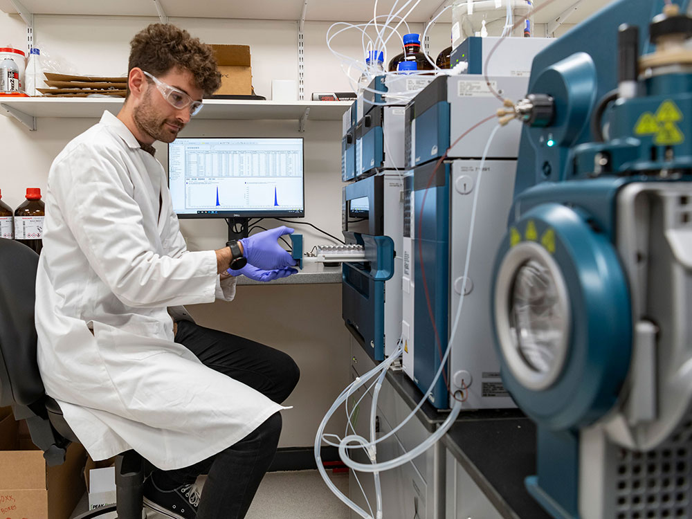 Attodiagnostics man in white coat in lab