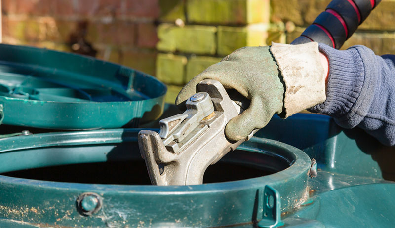 person filling heating oil tank